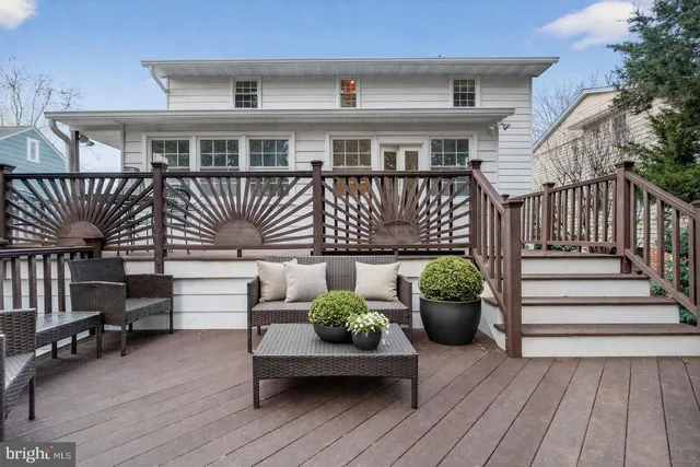 a view of a house with a deck and furniture