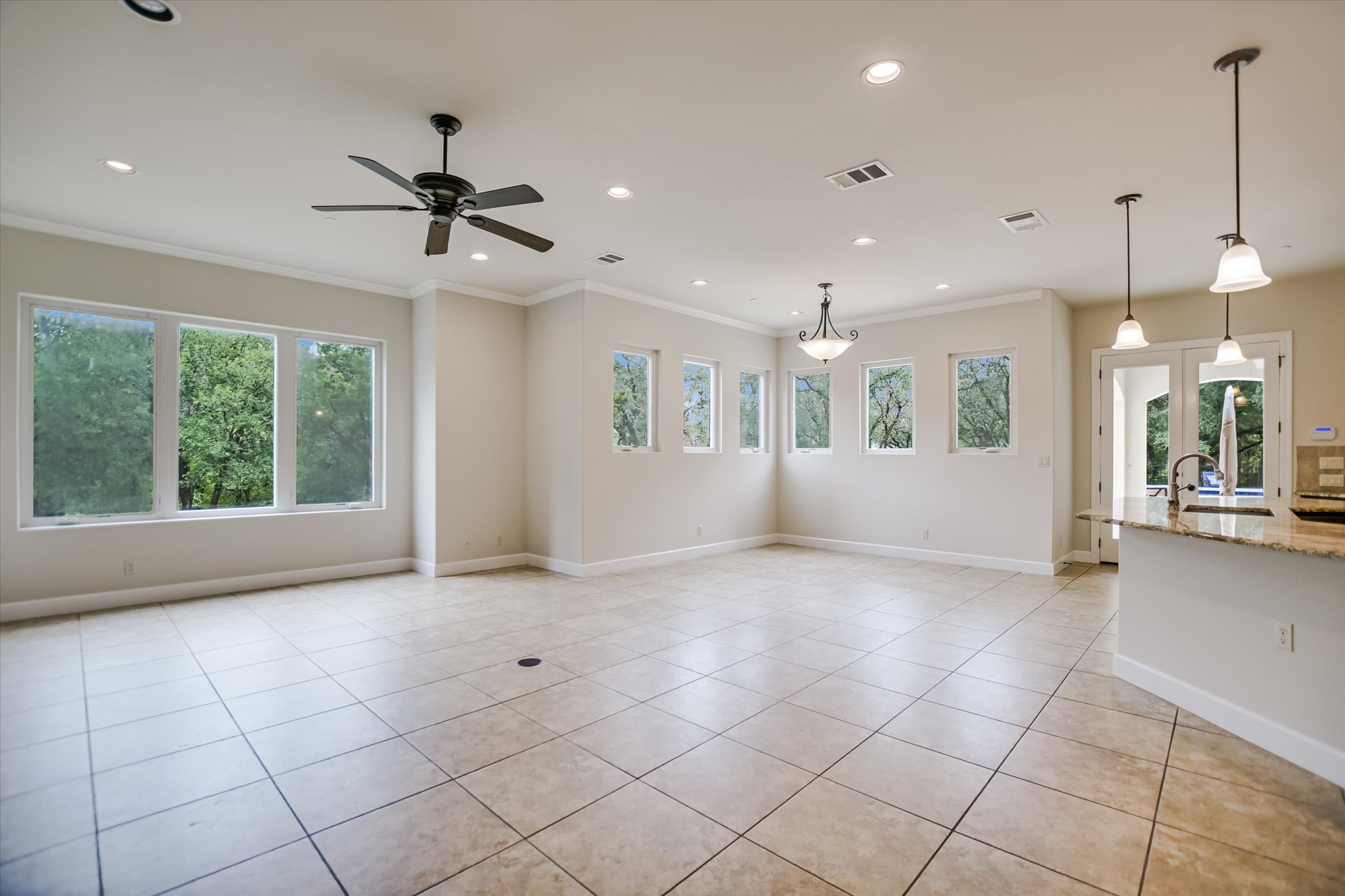 11 Inwood Circle Austin, TX 78746 - Photo 10 of 38 A spacious room with abundant natural light features ceramic tile flooring and recessed lighting.