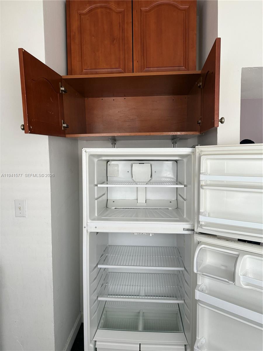 7611 Harding Avenue, Unit 7 Miami Beach, FL 33141 - Photo 11 of 11 a view of storage and utility room with racks on the wall