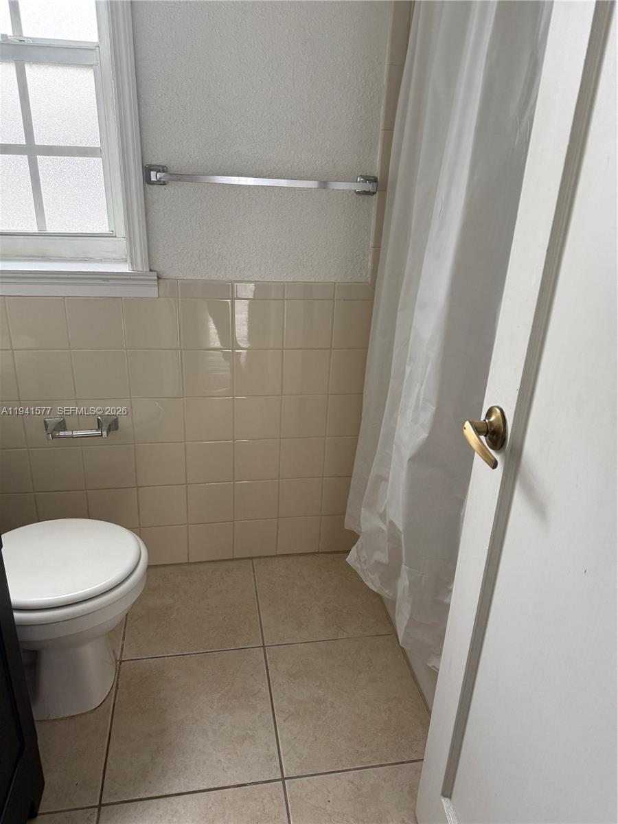 7611 Harding Avenue, Unit 7 Miami Beach, FL 33141 - Photo 5 of 9 a bathroom with a sink and toilet