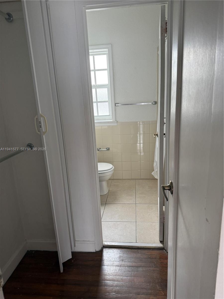 7611 Harding Avenue, Unit 7 Miami Beach, FL 33141 - Photo 7 of 11 a view of a bathroom with a sink and a toilet