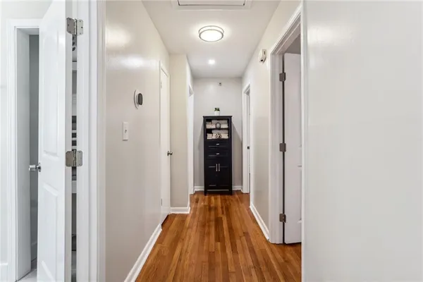 a view of a hallway with wooden floor