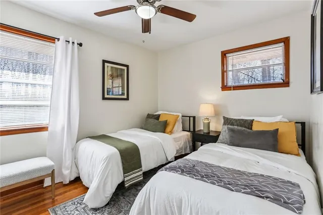 a bedroom with two beds and a window