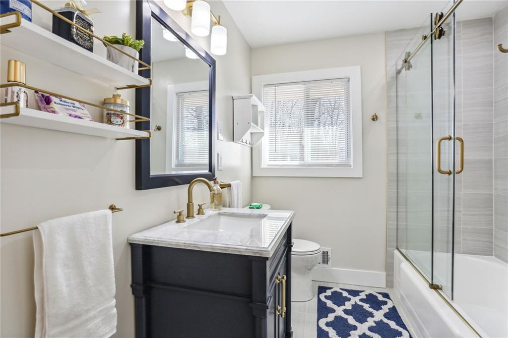 4667 Glore Road Southwest Mableton, GA 30126 - Photo 22 of 46 a bathroom with a sink a toilet and shower