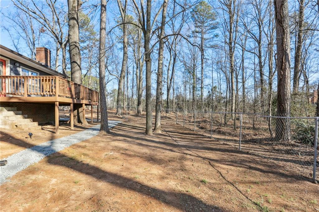 4667 Glore Road Southwest Mableton, GA 30126 - Photo 24 of 46 a view of a building with a bench in forest