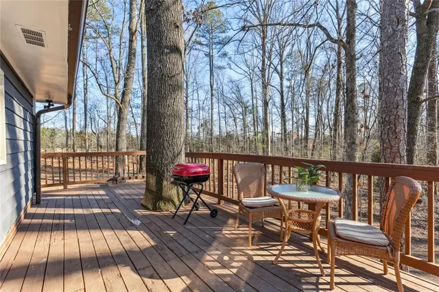 a view of balcony with wooden floor and outdoor seating