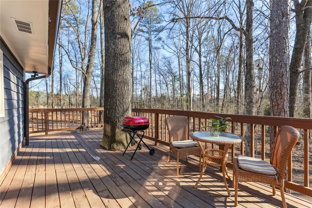 4667 Glore Road Southwest Mableton, GA 30126 - Photo 25 of 46 a view of balcony with wooden floor and outdoor seating