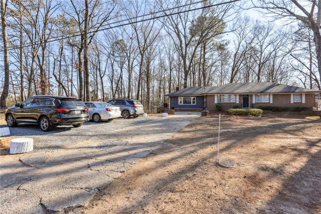 4667 Glore Road Southwest Mableton, GA 30126 - Photo 31 of 46 a car parked in front of white building