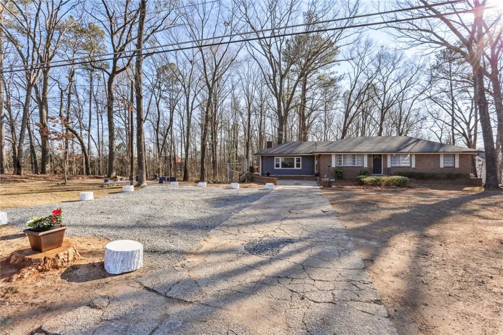 4667 Glore Road Southwest Mableton, GA 30126 - Photo 32 of 46 a front view of a house with a yard