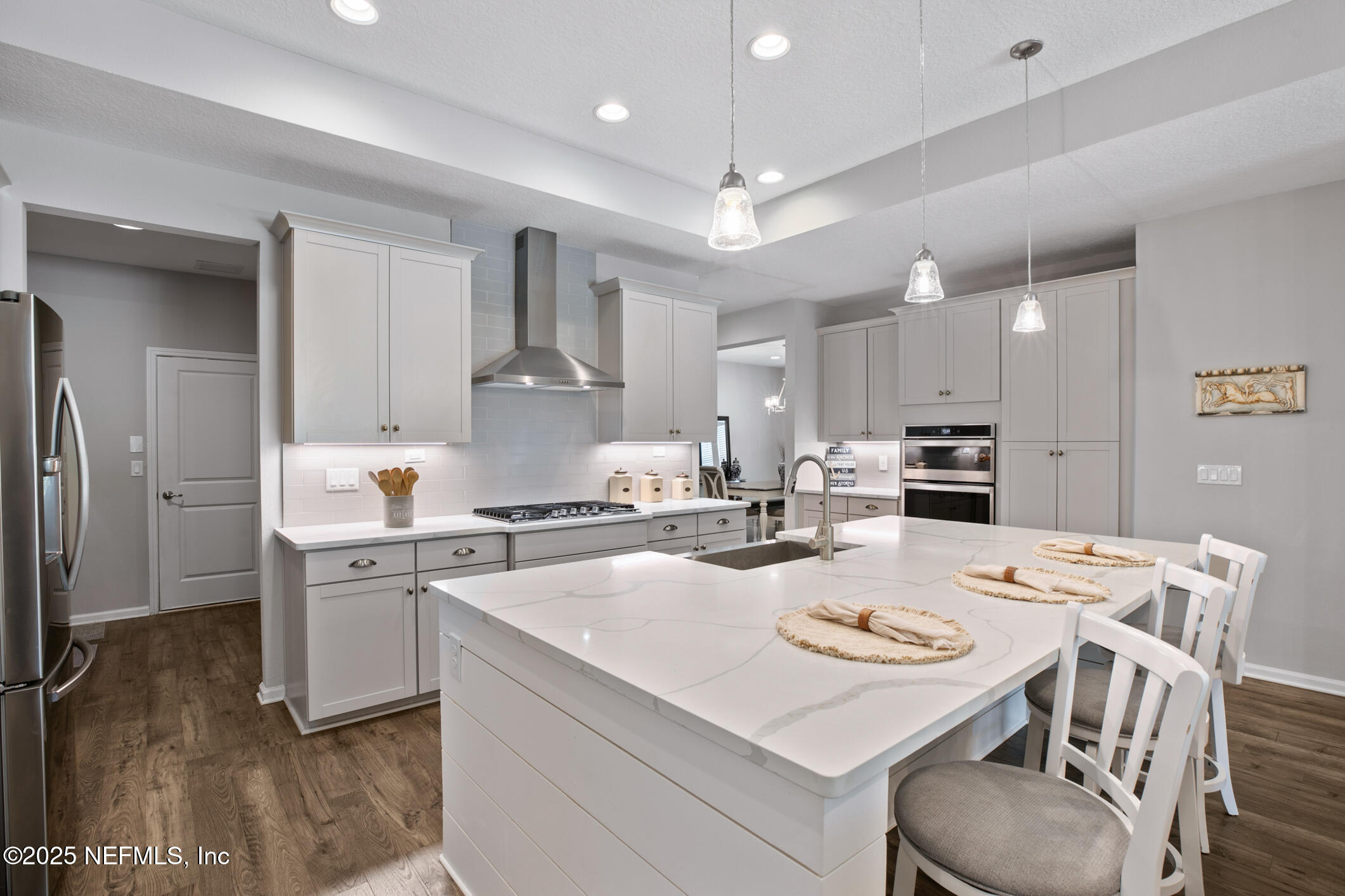 125 Holly Forest Drive St. Augustine, FL 32092 - Photo 29 of 96 a kitchen that has a lot of cabinets a sink and a stove in it