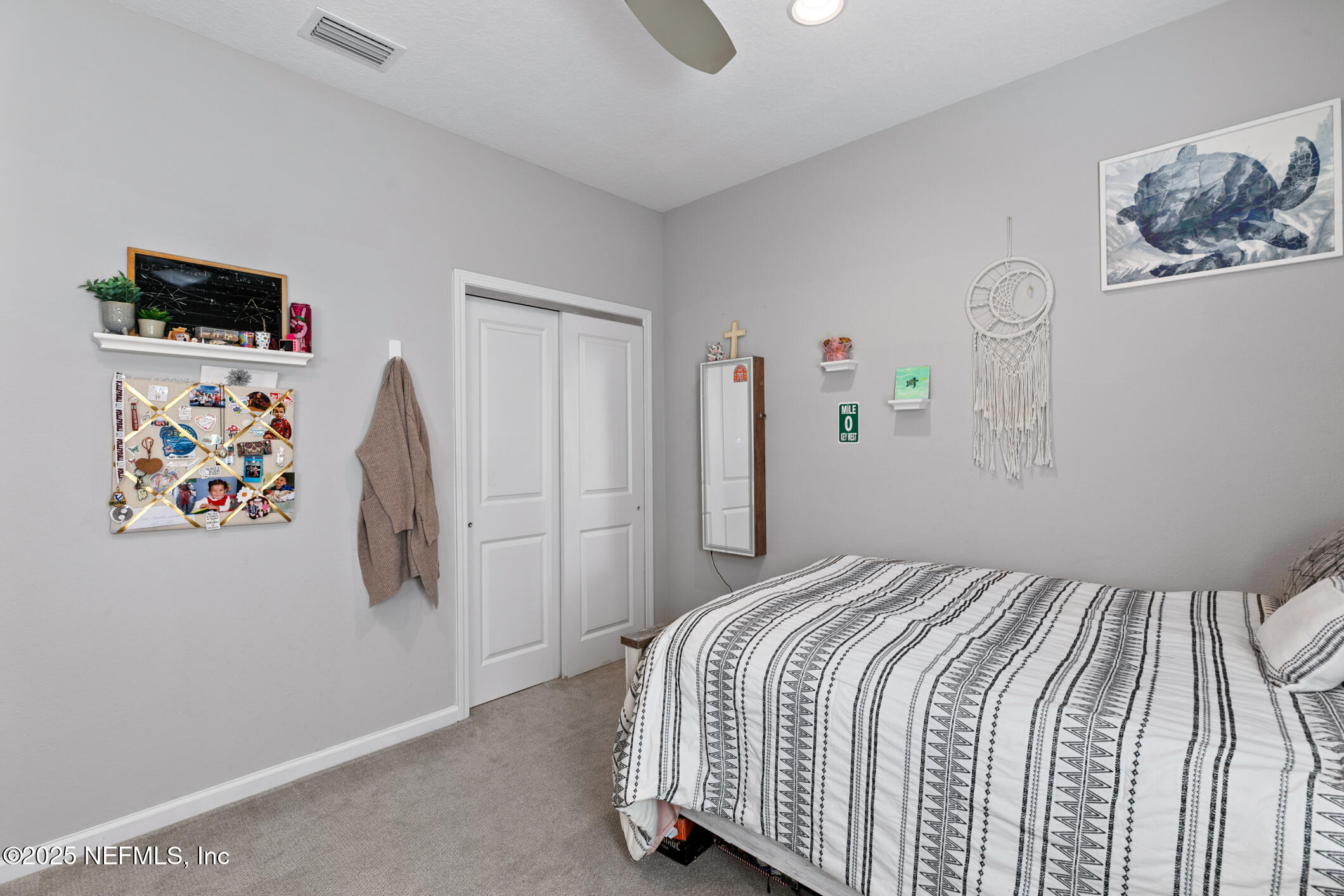 125 Holly Forest Drive St. Augustine, FL 32092 - Photo 52 of 96 a bedroom with a bed and a flat screen tv