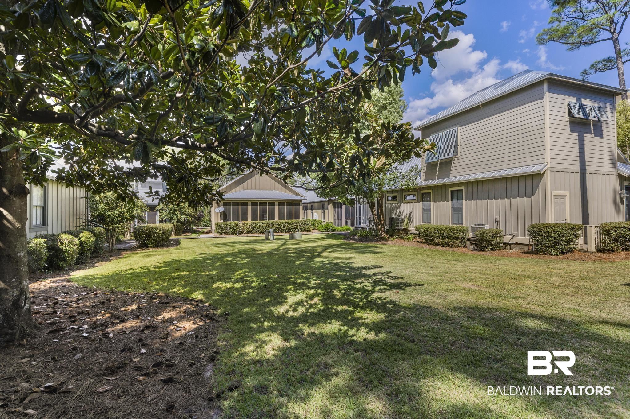 25773 Canal Road Orange Beach, AL 36561 - Photo 2 of 32 View of grassy yard with a sunroom