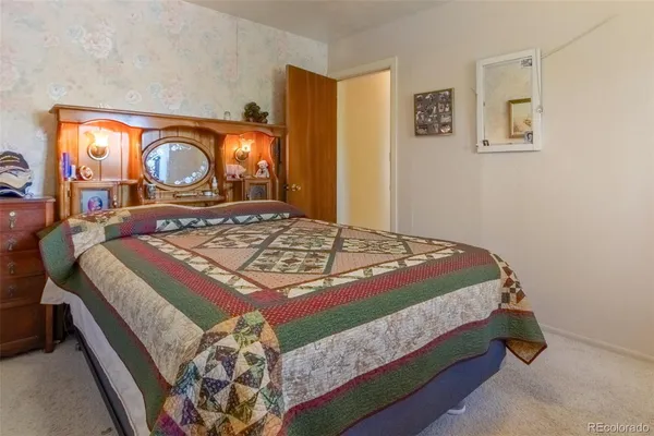 a bed sitting in a bedroom next to a window