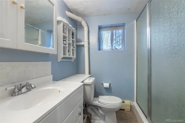a bathroom with a sink a toilet and mirror
