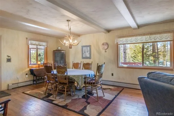 a view of a dining room with furniture window and wooden floor