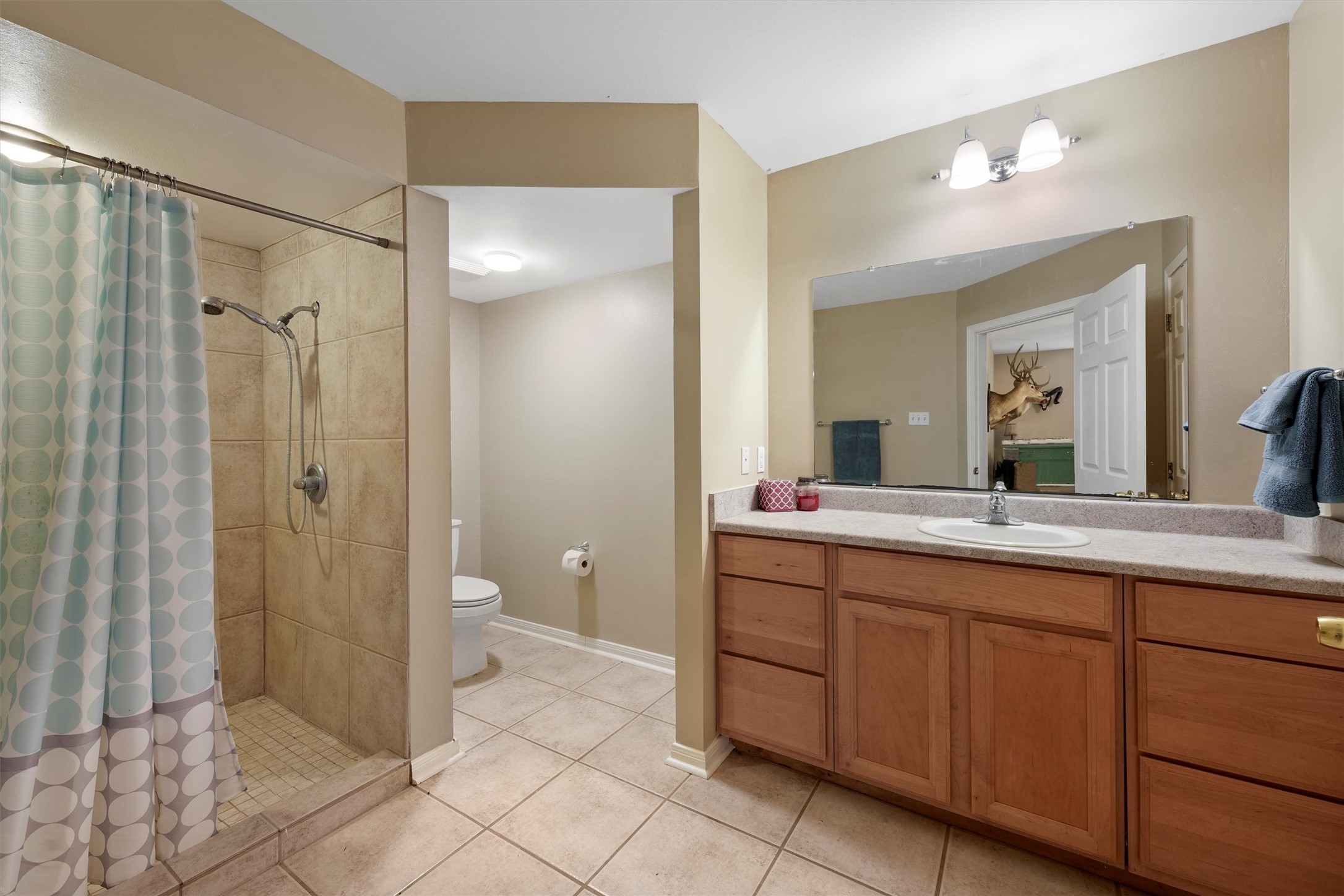 6803 Treaschwig Road Spring, TX 77373 - Photo 21 of 22 a spacious bathroom with a double vanity sink toilet and shower