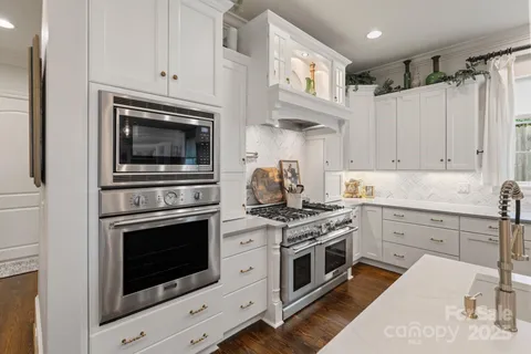 a kitchen with cabinets stainless steel appliances and a sink