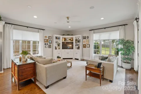 a living room with furniture and large windows