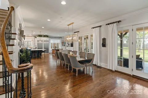 a dining room with furniture and wooden floor