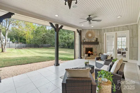 a living room with patio furniture and a floor to ceiling window