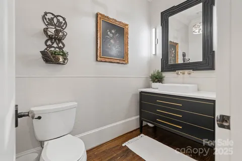 a bathroom with a toilet a sink and mirror