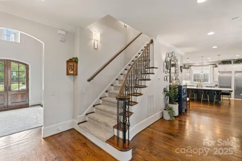 a view of entryway and hall with wooden floor