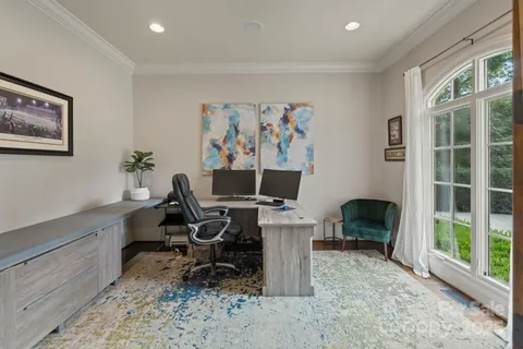 a view of a workspace with furniture and a window