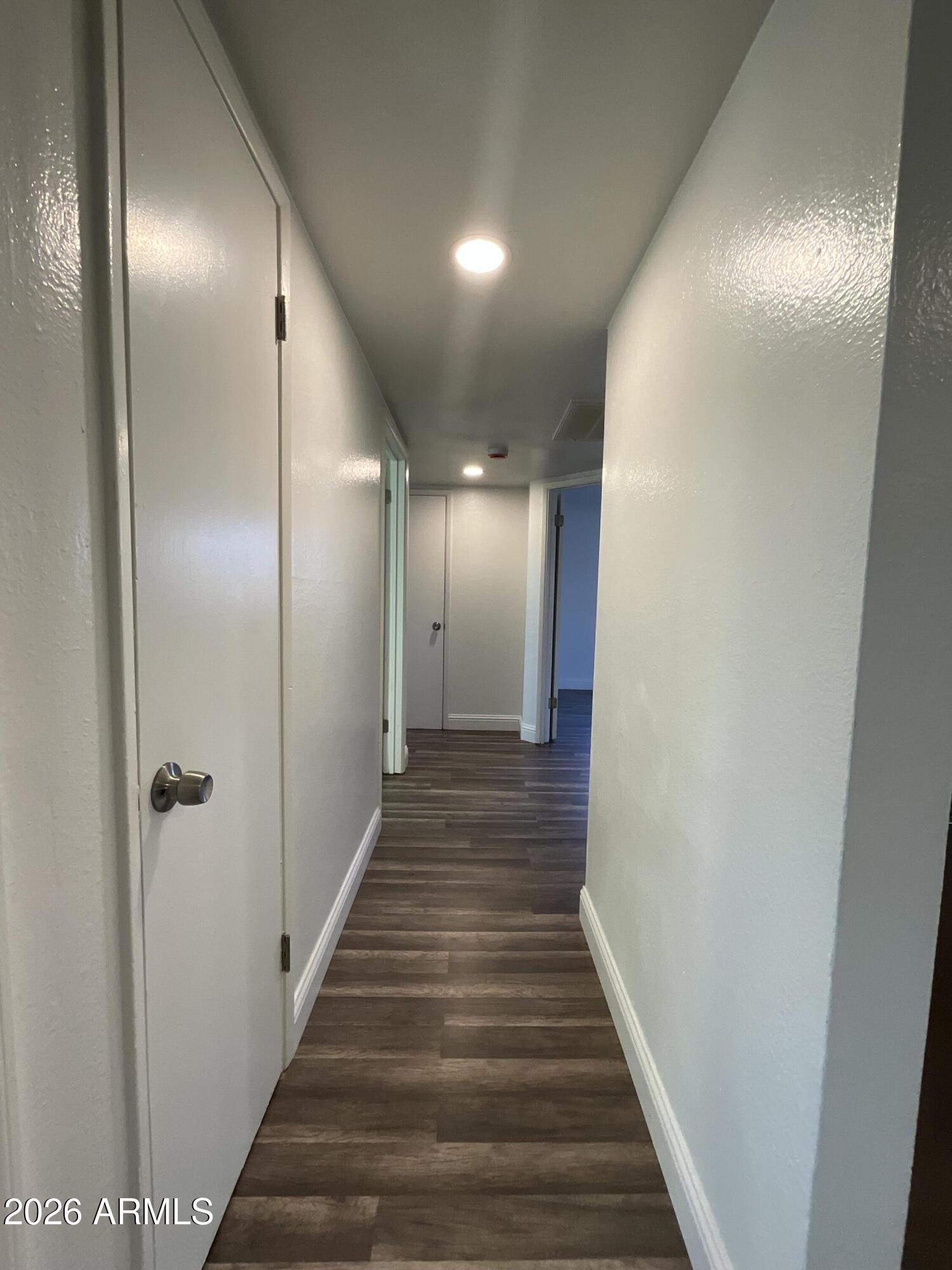 8052 West Pierson Street Phoenix, AZ 85033 - Photo 12 of 36 a view of a hallway with wooden floor