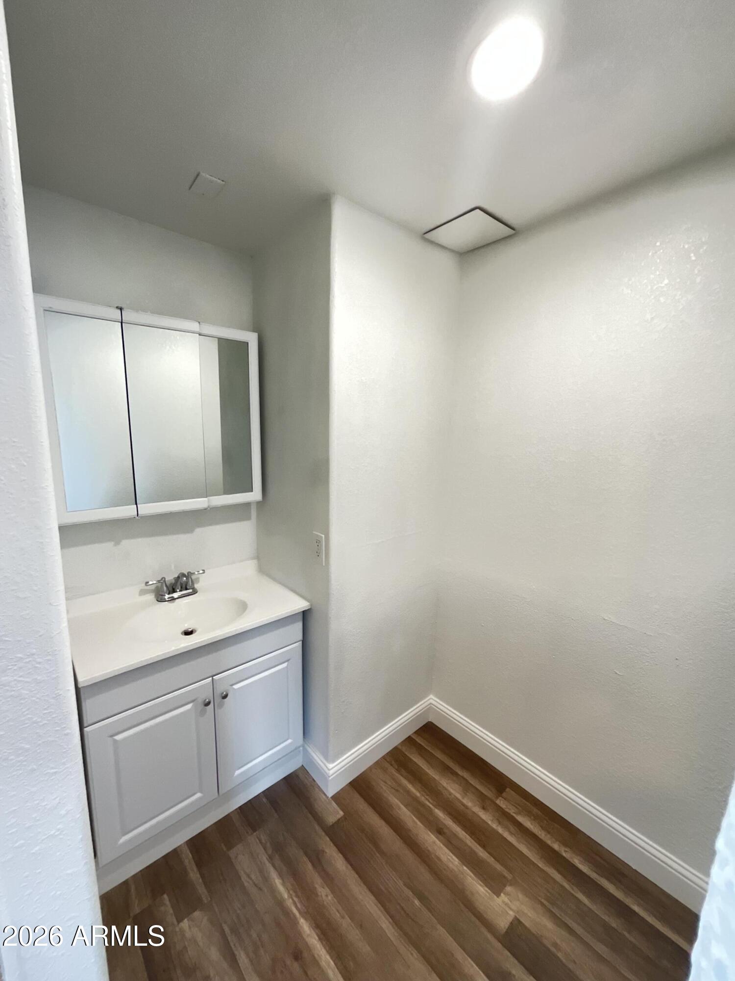 8052 West Pierson Street Phoenix, AZ 85033 - Photo 14 of 36 a bathroom with a sink and a mirror