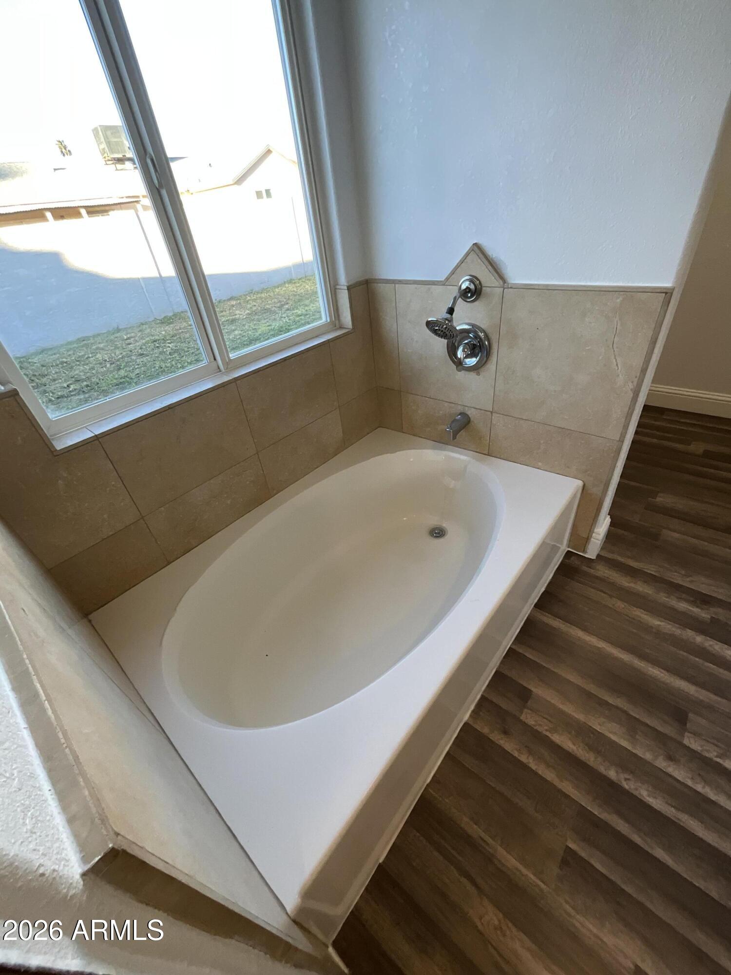 8052 West Pierson Street Phoenix, AZ 85033 - Photo 16 of 36 a bath tub sitting next to a window