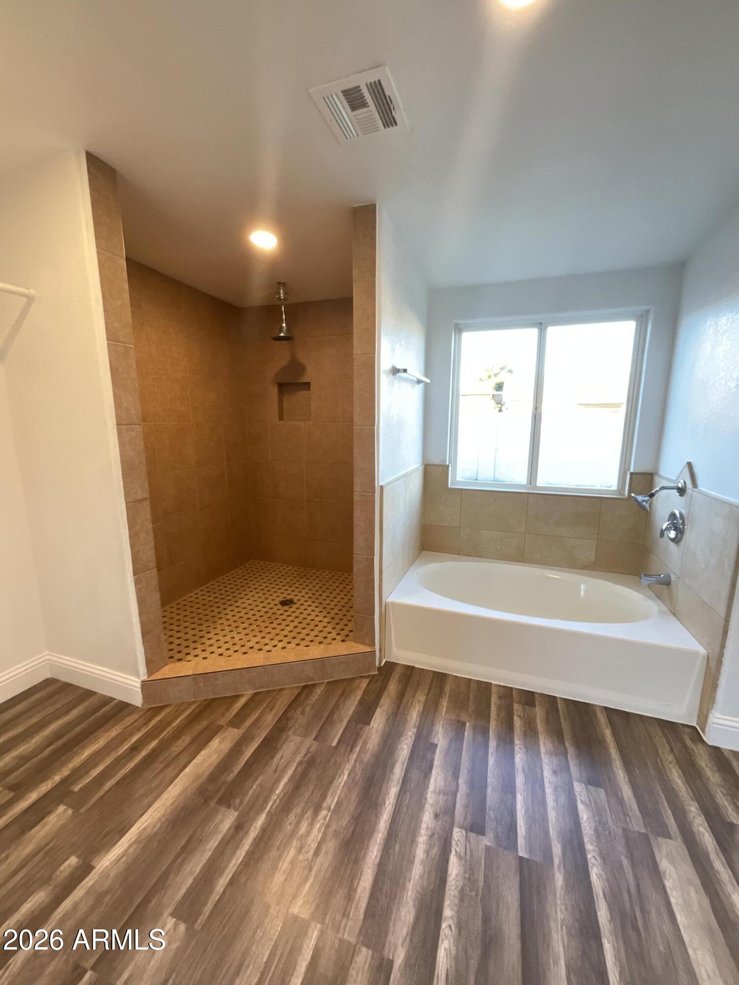 8052 West Pierson Street Phoenix, AZ 85033 - Photo 21 of 36 a bathroom with a tub and shower