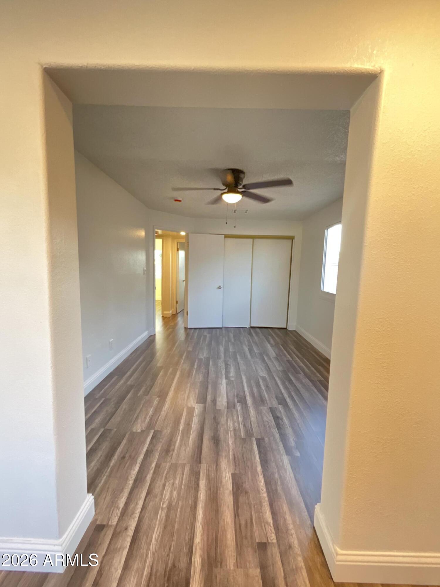 8052 West Pierson Street Phoenix, AZ 85033 - Photo 23 of 36 a view of empty room with wooden floor