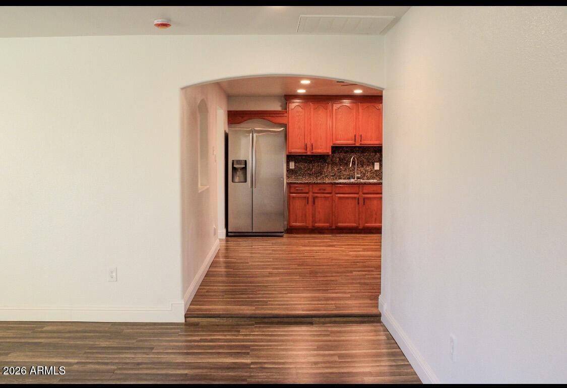 8052 West Pierson Street Phoenix, AZ 85033 - Photo 30 of 36 a view of a hallway with wooden floor and a hallway