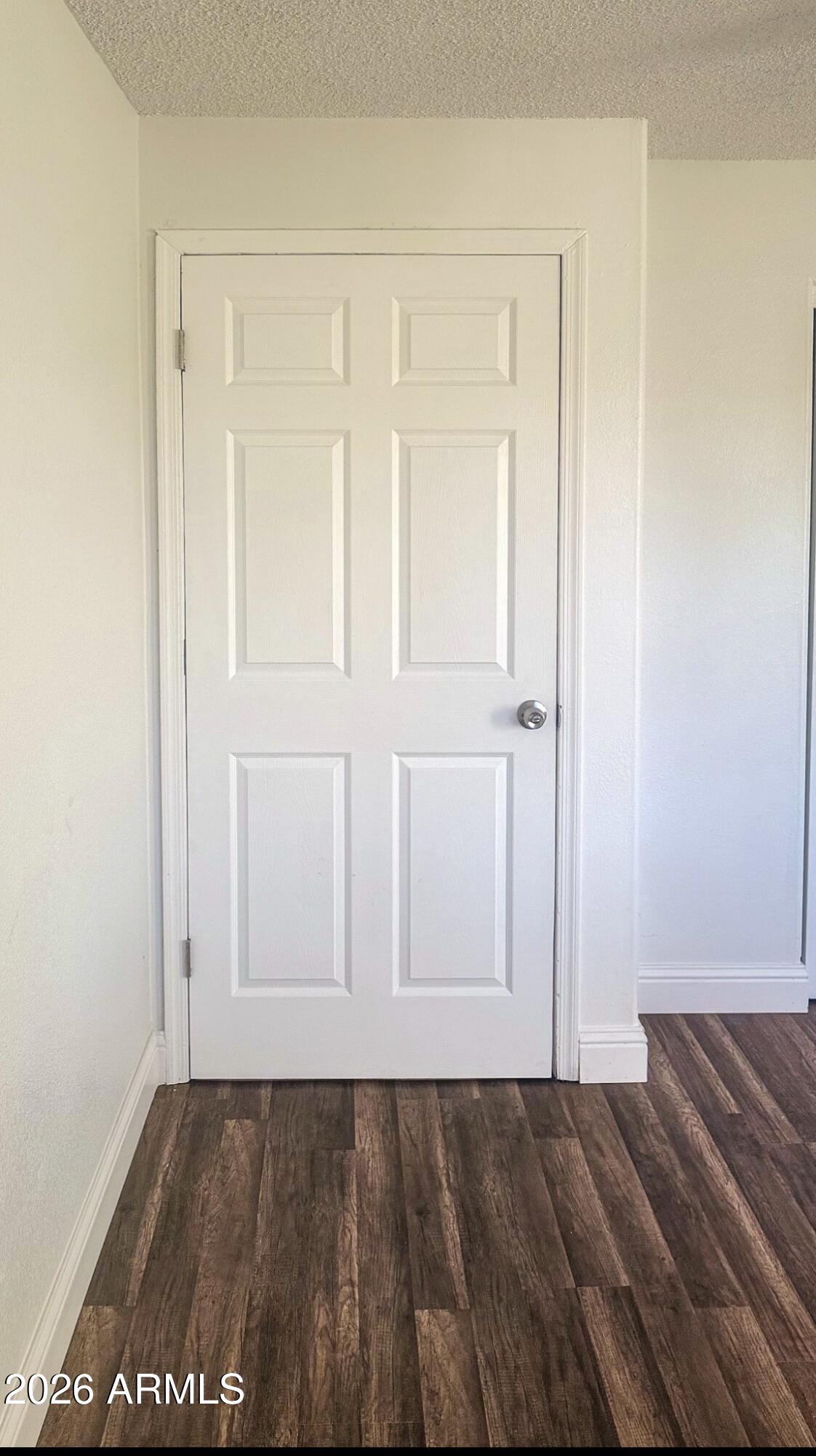 8052 West Pierson Street Phoenix, AZ 85033 - Photo 31 of 36 an empty room with wooden floor and closet