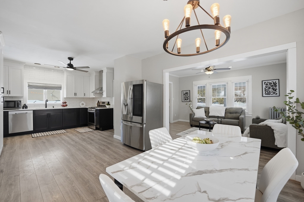 361 Prospect Avenue West Springfield, MA 01089 - Photo 4 of 35 a living room with stainless steel appliances kitchen island a table chairs and chandelier