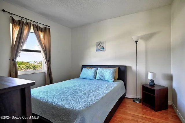 a bed sitting in a bedroom next to a window