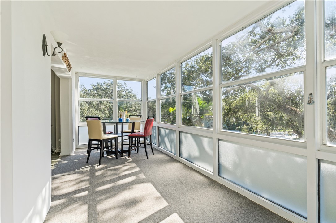 275 Date Palm Road, Unit 307 Vero Beach, FL 32963 - Photo 5 of 36 a dining room with furniture water view and a floor to ceiling window