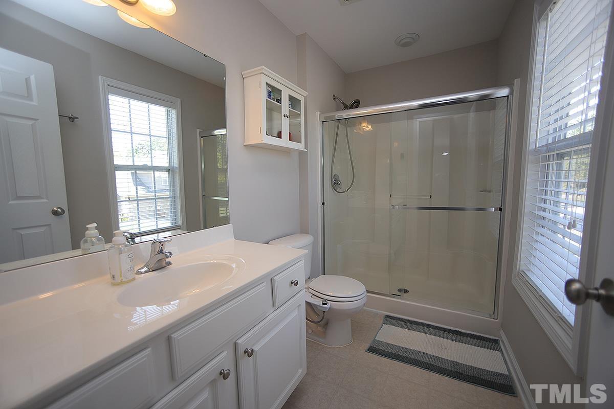 2656 Andover Glen Road Raleigh, NC 27604 - Photo 11 of 18 a bathroom with a sink a toilet and shower