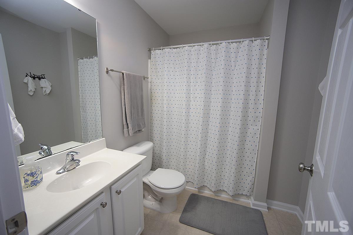 2656 Andover Glen Road Raleigh, NC 27604 - Photo 13 of 18 a bathroom with a sink toilet and shower