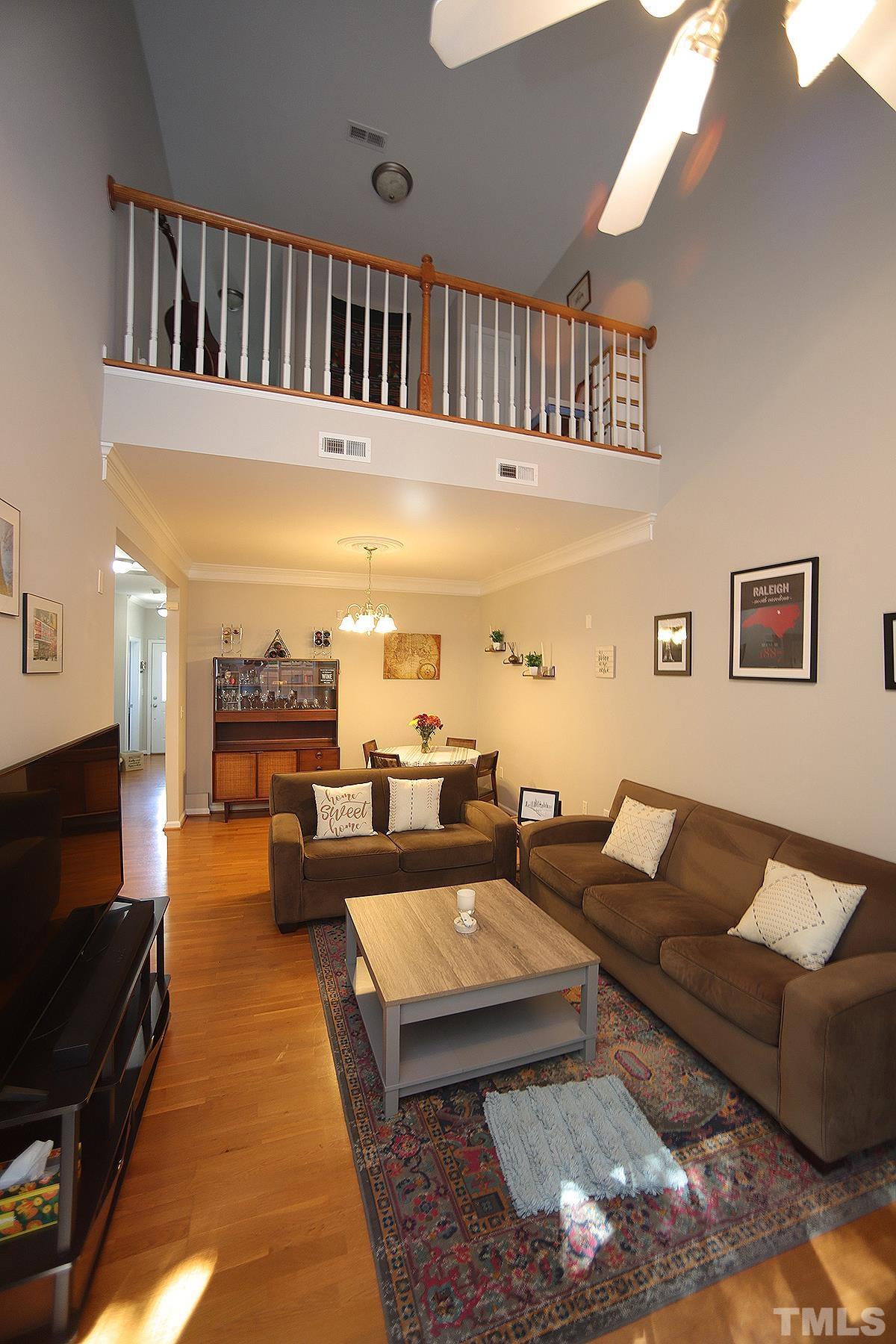 2656 Andover Glen Road Raleigh, NC 27604 - Photo 4 of 18 a living room with furniture and a flat screen tv