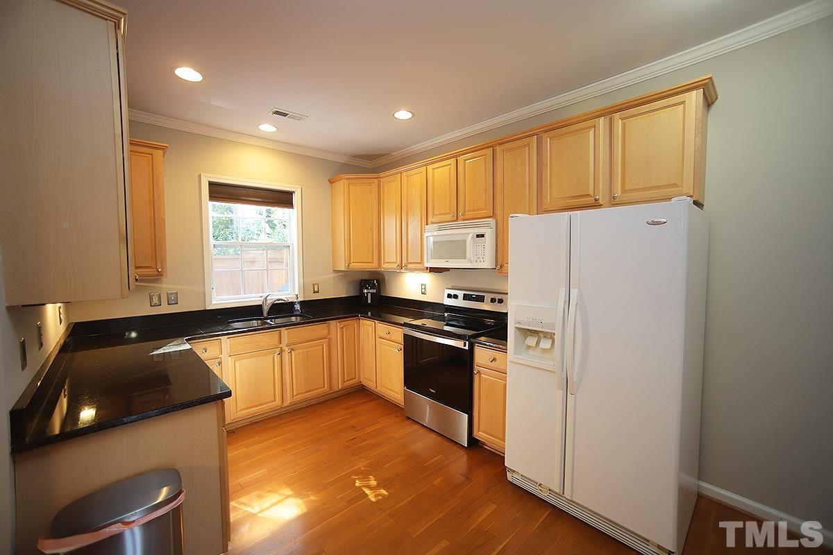 2656 Andover Glen Road Raleigh, NC 27604 - Photo 6 of 18 a kitchen with a refrigerator a sink and cabinets
