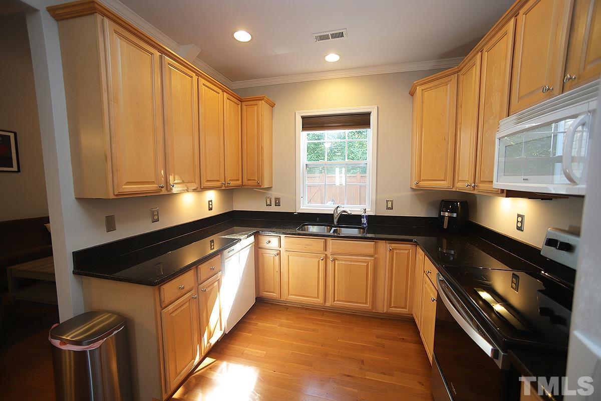 2656 Andover Glen Road Raleigh, NC 27604 - Photo 7 of 18 a kitchen with stainless steel appliances granite countertop a sink a stove and cabinets