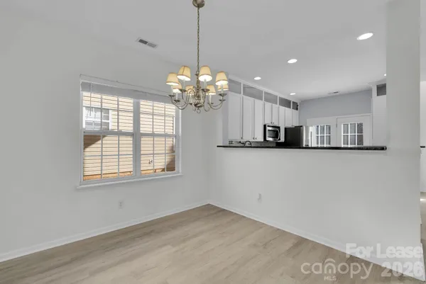 a view of a kitchen with an empty space and a window