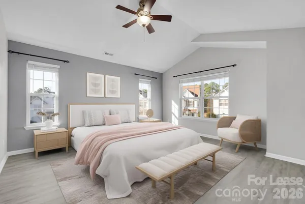 a bedroom with a bed and a large window