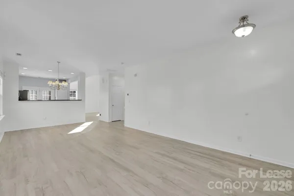 a view of a kitchen with wooden floor and a kitchen