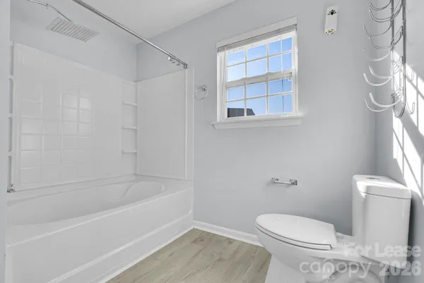 a bathroom with a toilet and a bathtub