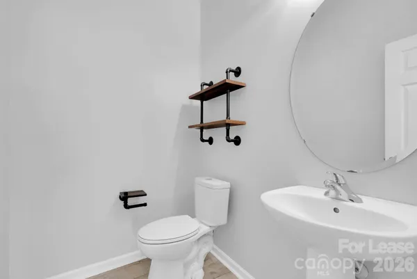 a bathroom with a sink toilet and a mirror