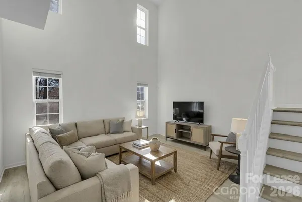 a living room with furniture flat screen tv and a fireplace