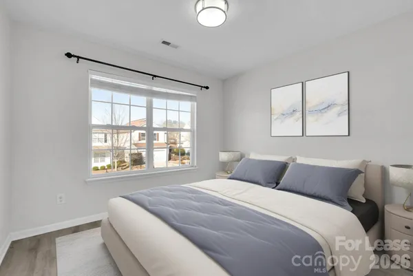 a bedroom with a bed and a window