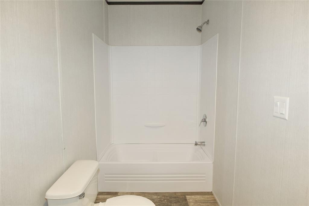 60 Tecumseh Road Valley View, TX 76272 - Photo 13 of 20 Full-sized bathtub with an integrated shower, chrome fixtures, and a white surround